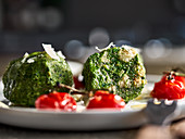 Spinach dumplings with roasted cherry tomatoes