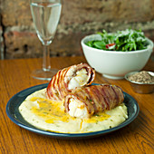 Monkfish wrapped in bacon on a creamy mashed potato