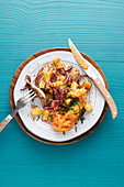 Pork cutlet topped with pineapple and red onion served with mashed sweet potatoes