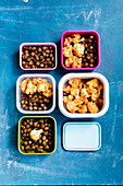Oven-roasted chickpeas and cauliflower with garam masala in plastic boxes