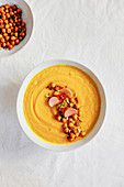Carrot soup with baked chickpeas and pickled radishes