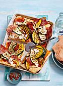 Pizza with grilled zucchini, ham and feta