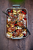 Braised rabbit legs with potatoes and olives