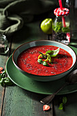 Strawberries smoothie bowl with basil, lime and chia seeds