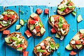 Bruschetta with watermelon, feta cheese, cucumber and basil