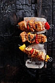 Chicken skewers with paprika and zucchini on burn board