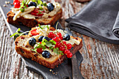 Sultana bread slices with marinated mozzarella, blueberries and red currants