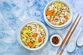 Spring vegetable soup with dumplings and rice noodles