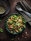 Vegan rice salad with spinach leaves and peanuts