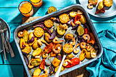 Baked vegetables with shrimps (corn, red onion, peppers, potatoes)