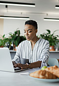 Businesswoman working on a laptop in an office