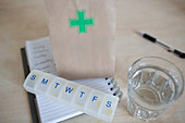Prescription bag and pill box with glass of water