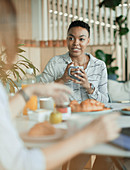 Businesswomen talking in breakfast meeting in office