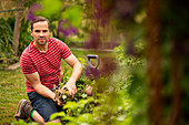 Confident man harvesting vegetables in garden