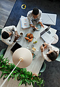 Business people talking over breakfast in office meeting