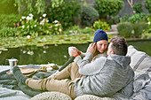 Affectionate romantic couple drinking coffee on luxury patio
