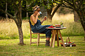 Woman eating cake at garden table