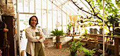 Confident female florist in greenhouse shop
