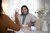 Daughter helping mother with prescription medication