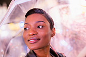 Young woman with short black hair under umbrella