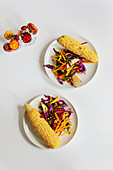Red cabbage salad with brown lentils, apple and beetroot, with corn on the cob