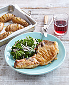 Pork cutlets with parsley salad and baked potatoes