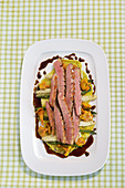 Duck breast with steamed vegetables and chanterelles