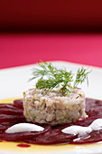Soused herring tartare on beetroot carpaccio