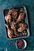 Braised duck legs with walnuts and pomegranate seeds