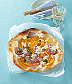 Pumpkin pizza with red onions and feta