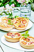 Small egg and bacon tartlets with tomatoes