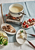 Light cheese fondue with bread and vegetables