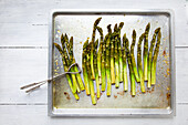 Roasted green asparagus on a baking tray