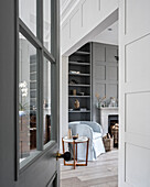 Open transom door to the open living room in shades of gray