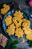 Vintage plate full of gingerbread cookies on wooden table