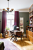 Desk in front of arched window in study