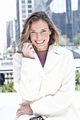 Joyful woman in white coat