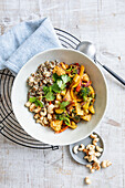 Vegetarian stir-fry with quinoa, cashews, and cilantro