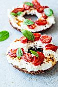 Breakfast bagel with feta and stewed tomatoes
