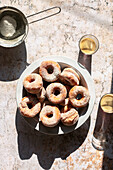 Fried doughnuts coated with icing sugar