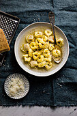 Homemade tortellini in broth with grated cheese