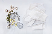 Christmas decorations in silver and white napkins