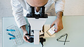 Scientist using a microscope