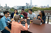 Business people meeting on urban balcony, London, UK