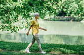Mature woman walking by a lake