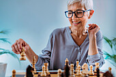 Senior woman playing chess