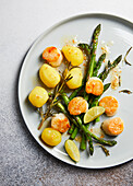 Roasted scallops with potatoes and green asparagus