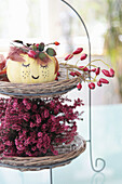 Autumn arrangement of heather, pumpkin face and rose hips