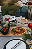 Set table with pizza outside