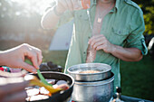 Mid section of man preparing food outdoors